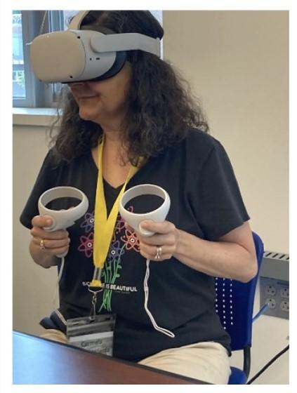 UNH Tech Camp Director, Dr. Amato-Wierda, interacting with a DNA model using the Oculus VR headset.