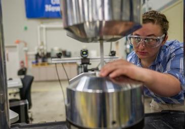 NH BioMade researcher working with equipment in a lab